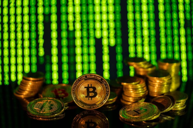 Spike +500 Amrix: bitcoin coins on a dark surface